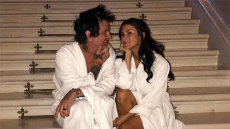 Brittany and Tommy posing in a bathrobe